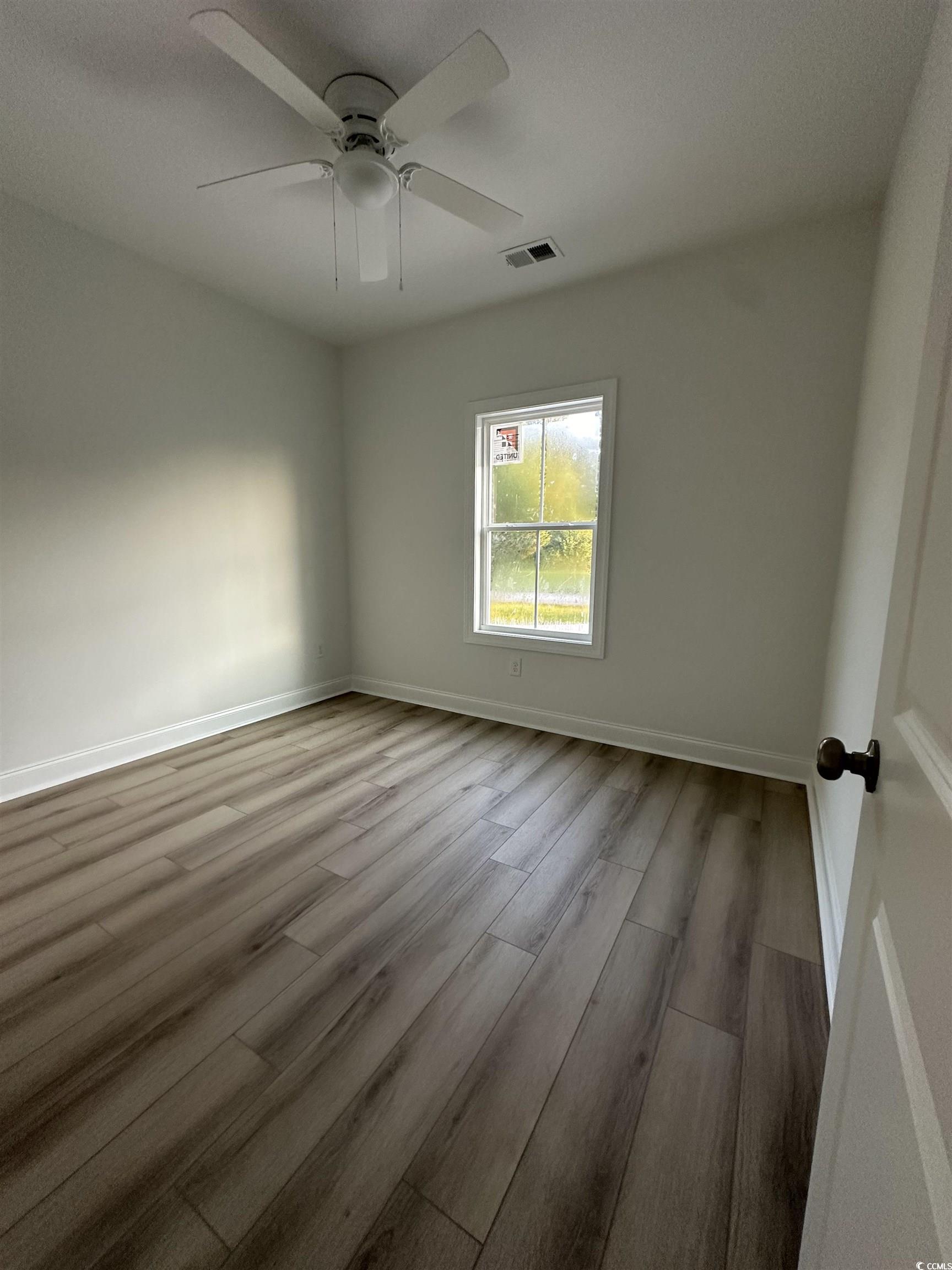 Spare room with light wood-type flooring and ceili