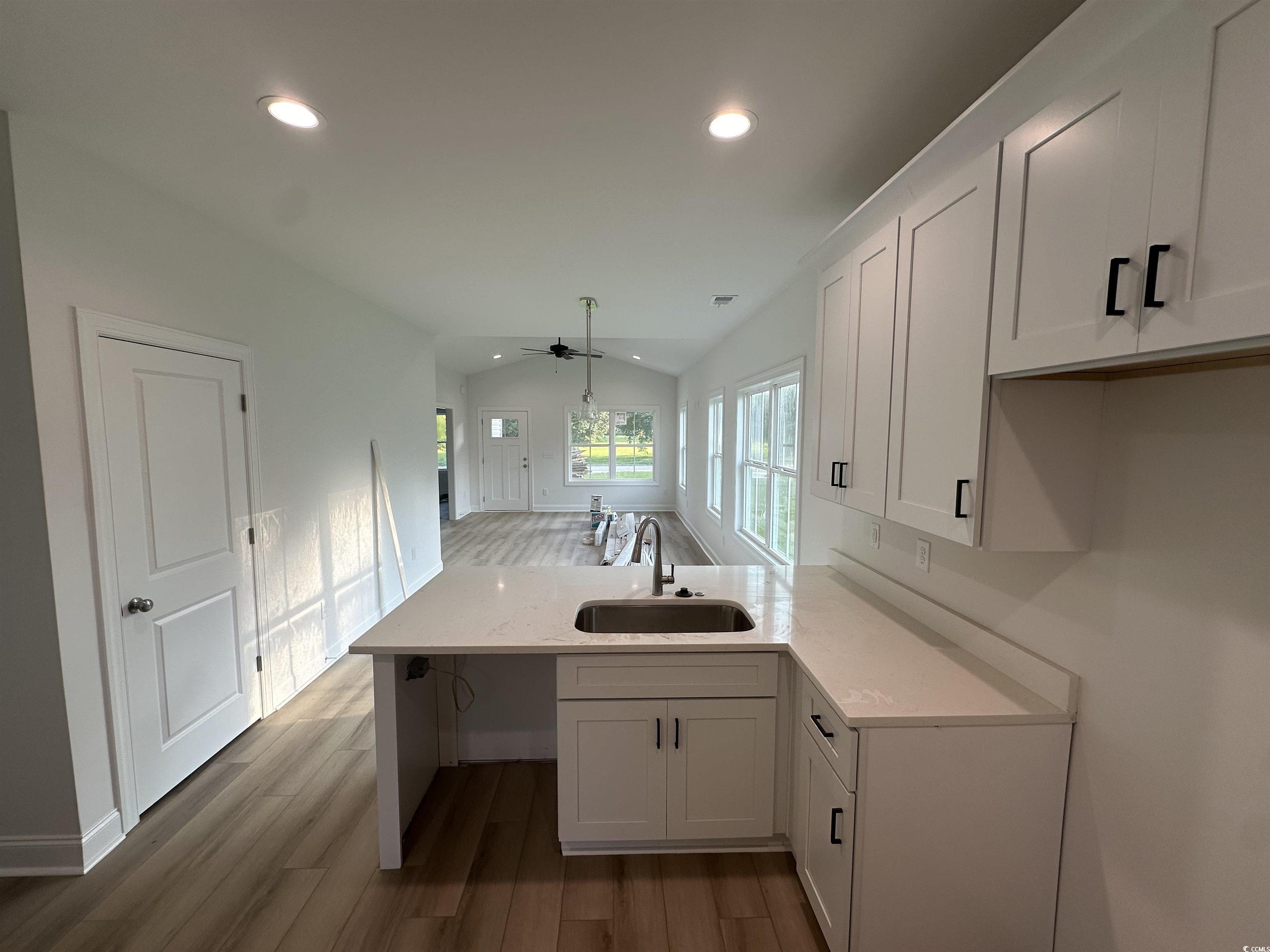 3474 Alton Road Loris, SC 29569 - Photo 10 of 16 Kitchen featuring white cabinetry, wood-type floor