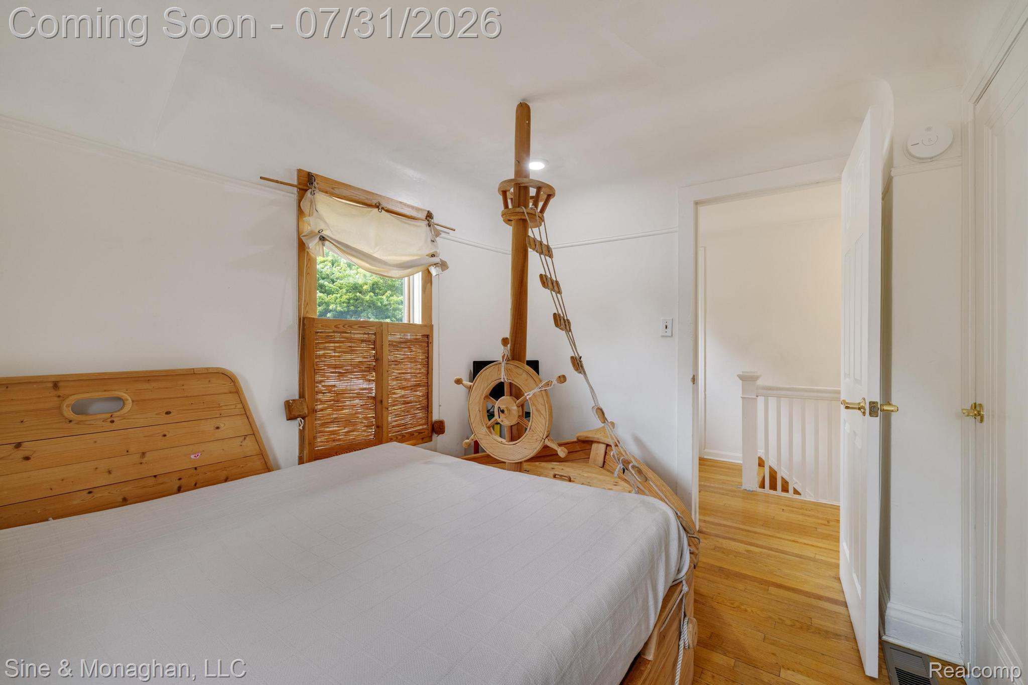 417 Cloverly Road Grosse Pointe, MI 48236 - Photo 26 of 70 Bedroom featuring wood-finish flooring, white walls, and a window with custom wood shutters