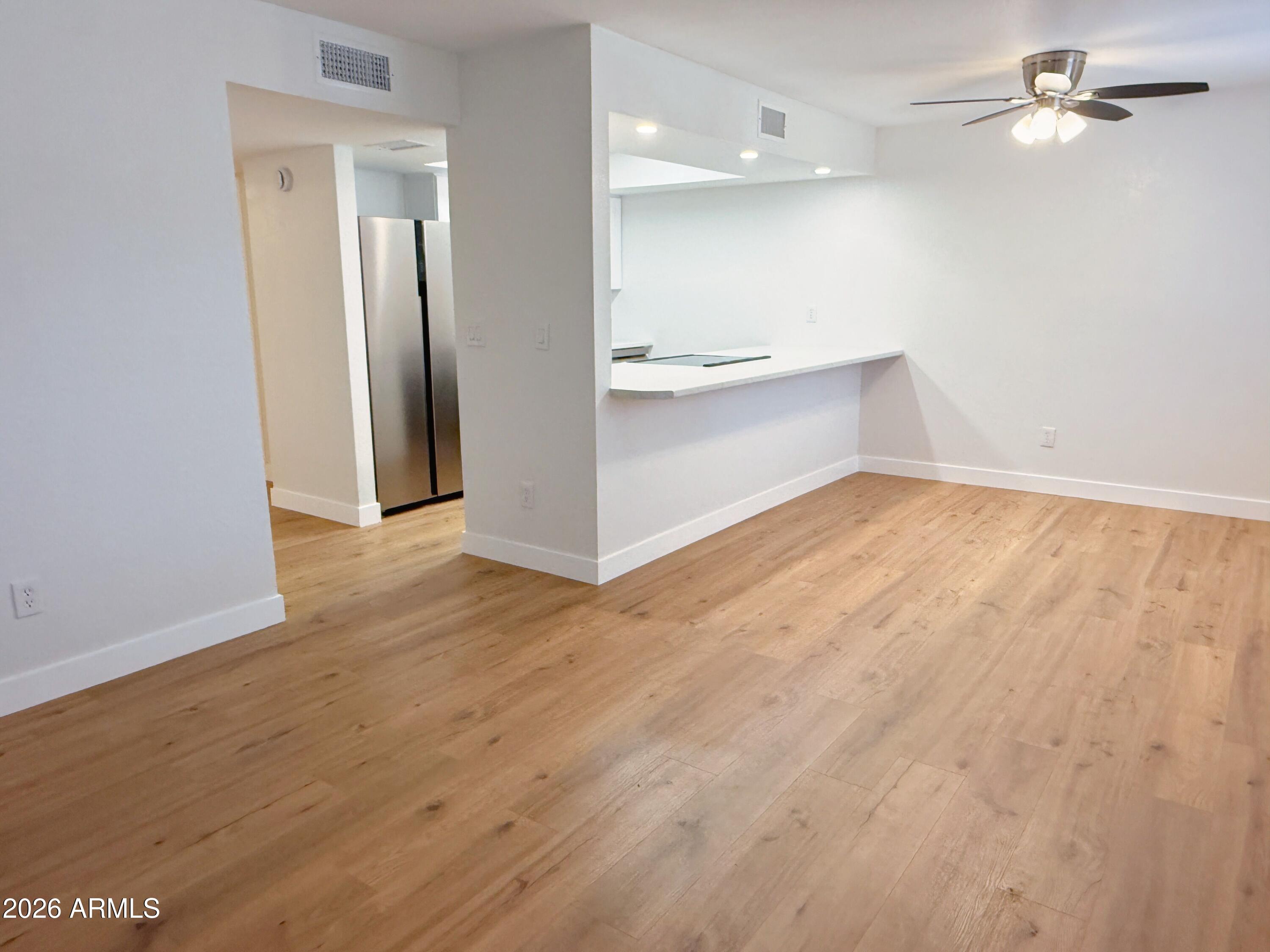 18202 North Cave Creek Road, Unit 148 Phoenix, AZ 85032 - Photo 3 of 19 wooden floor in an empty room