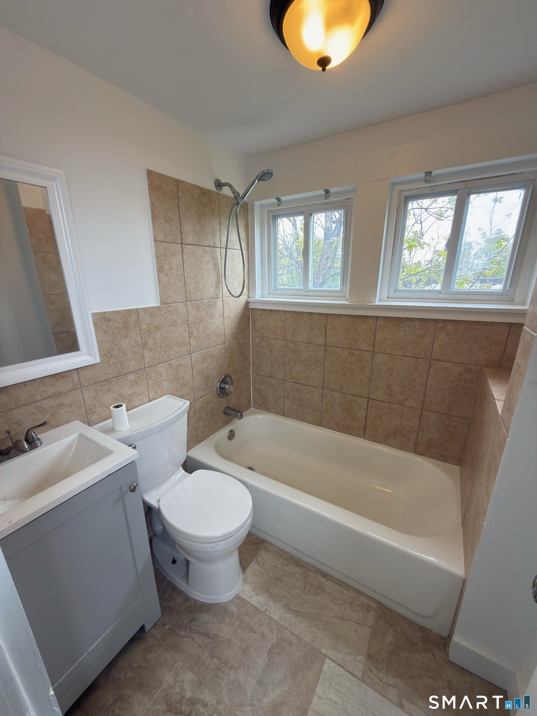 10 Beatrice Street, Unit 3 Bridgeport, CT 06607 - Photo 3 of 6 a bath room with a toilet a bath tub and a sink