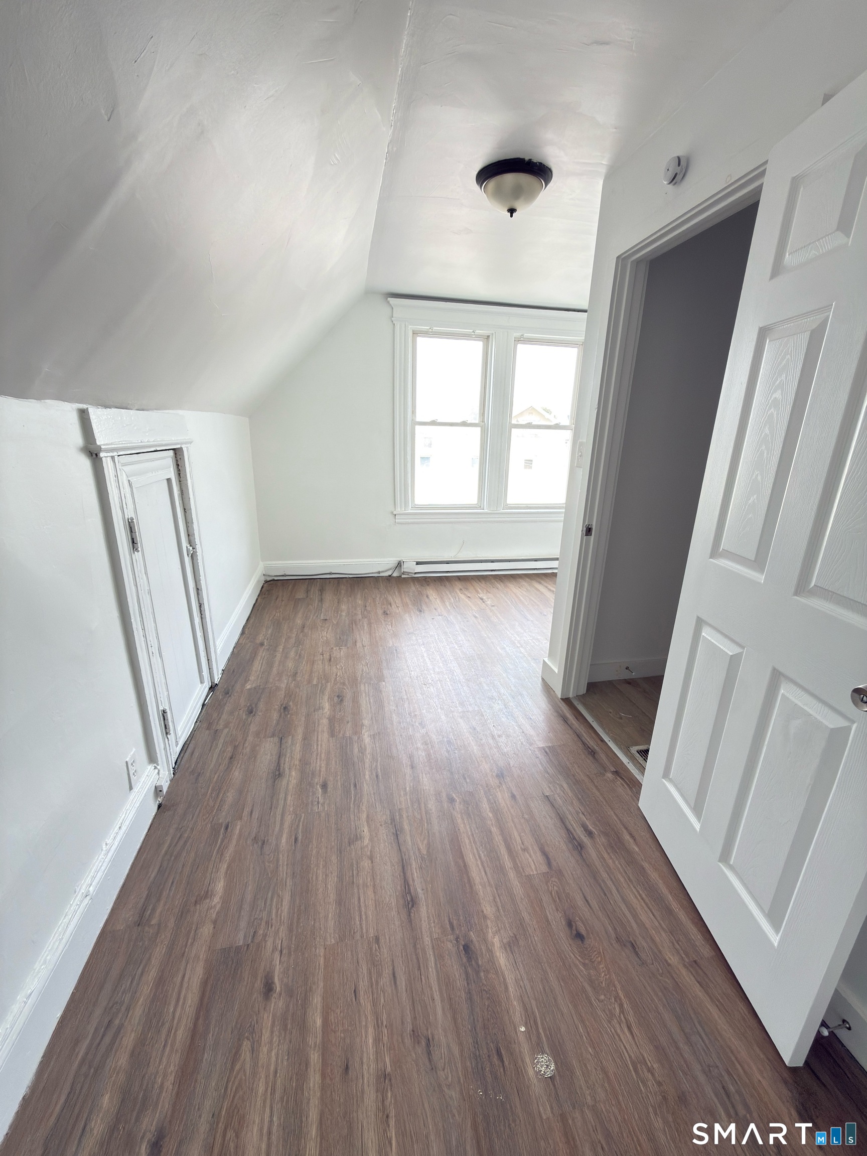 10 Beatrice Street, Unit 3 Bridgeport, CT 06607 - Photo 5 of 6 wooden floor in an empty room with a window