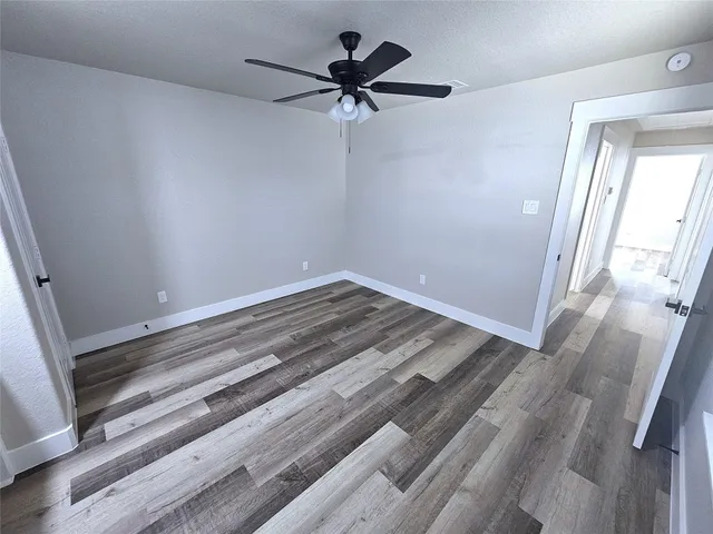 a view of a room with a ceiling fan