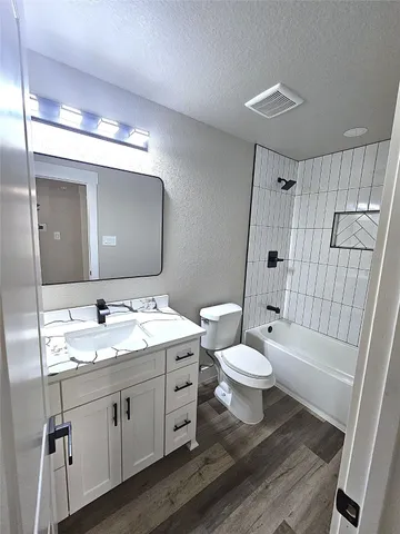 a bathroom with a double vanity sink toilet and shower
