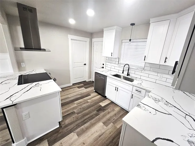 a large white kitchen with sink stove and refrigerator