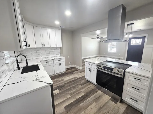 a kitchen with a stove oven and sink