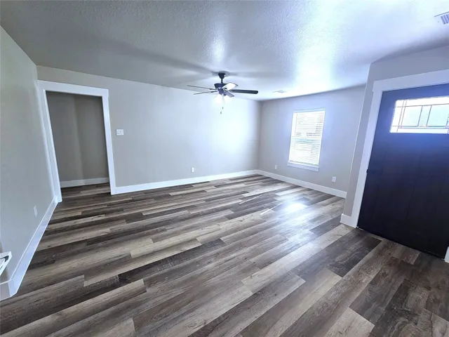 wooden floor in an empty room with a window