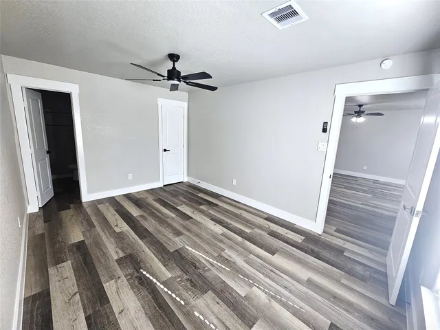 a view of a closet area with hardwood floor