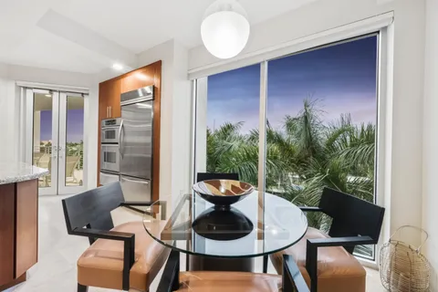 a living room with furniture large window and a flat screen tv
