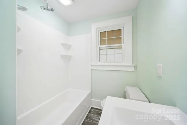 a bathroom with a bathtub and window