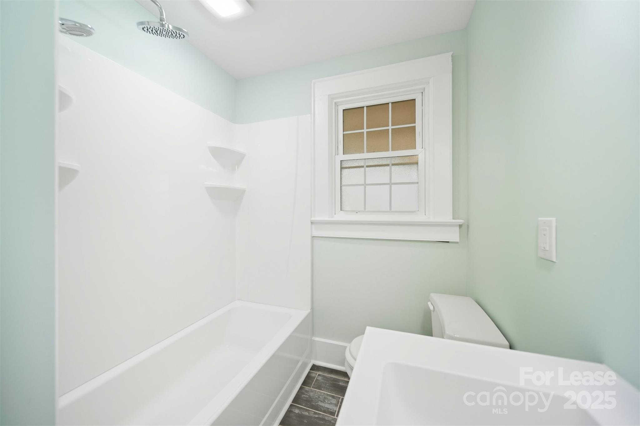 1234 11th Street Northwest Hickory, NC 28601 - Photo 11 of 19 a bathroom with a bathtub and window