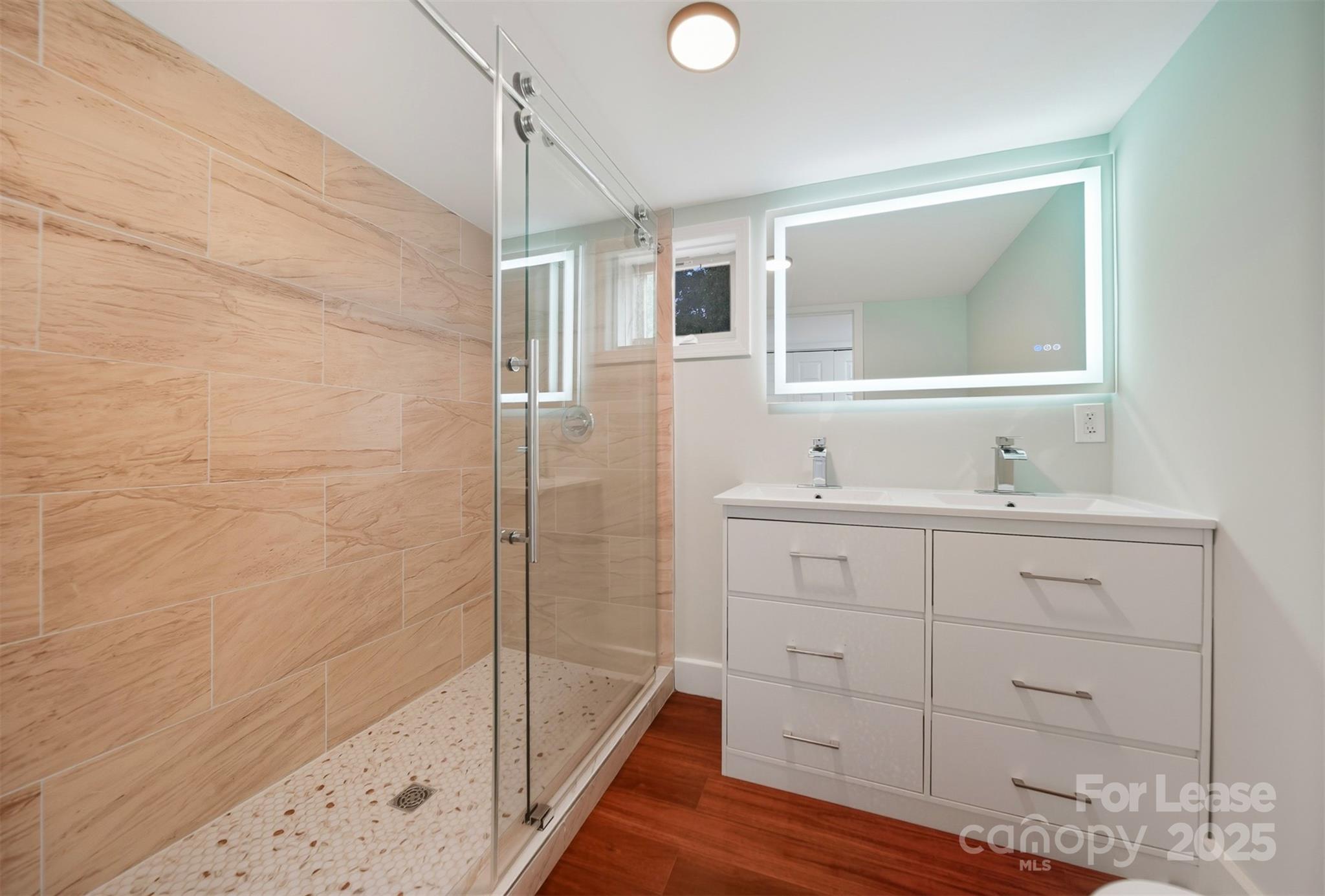 1234 11th Street Northwest Hickory, NC 28601 - Photo 12 of 19 a bathroom with a sink a mirror and shower