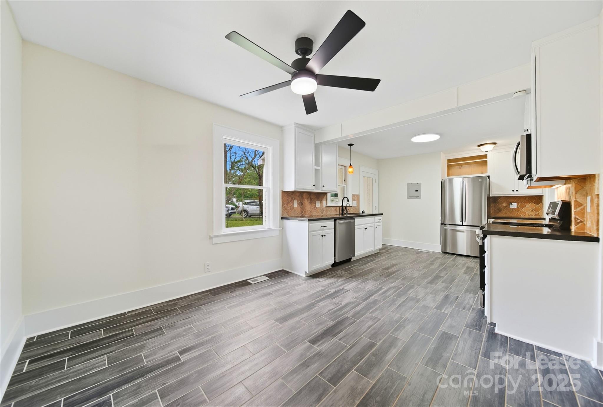 1234 11th Street Northwest Hickory, NC 28601 - Photo 3 of 19 a living room with stainless steel appliances kitchen island wooden floors and white walls