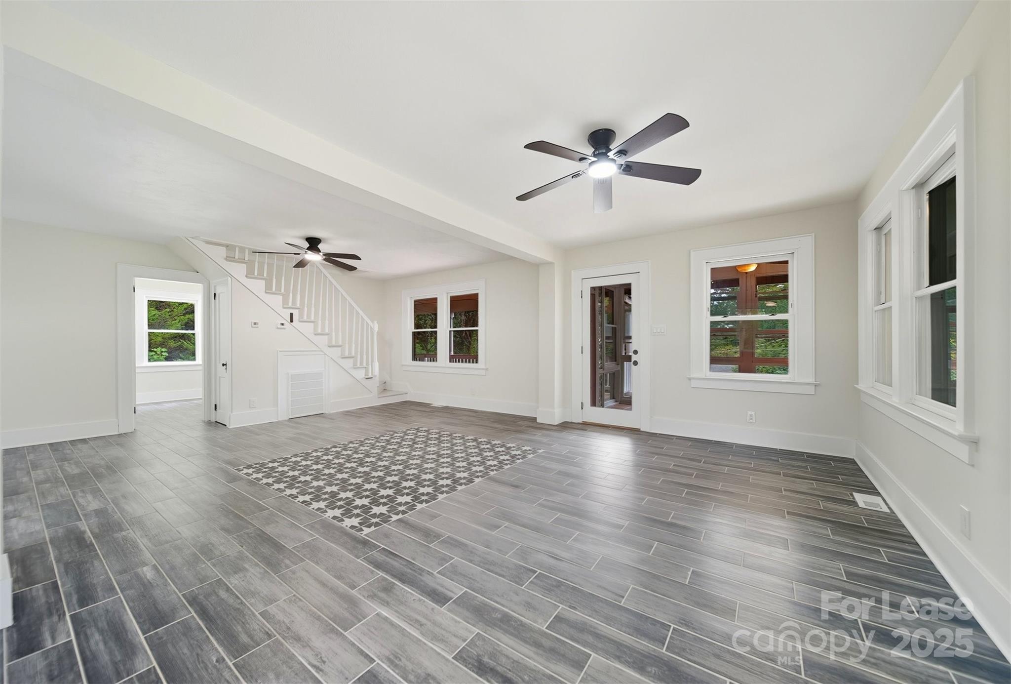 1234 11th Street Northwest Hickory, NC 28601 - Photo 8 of 19 a view of an empty room with a window and wooden floor