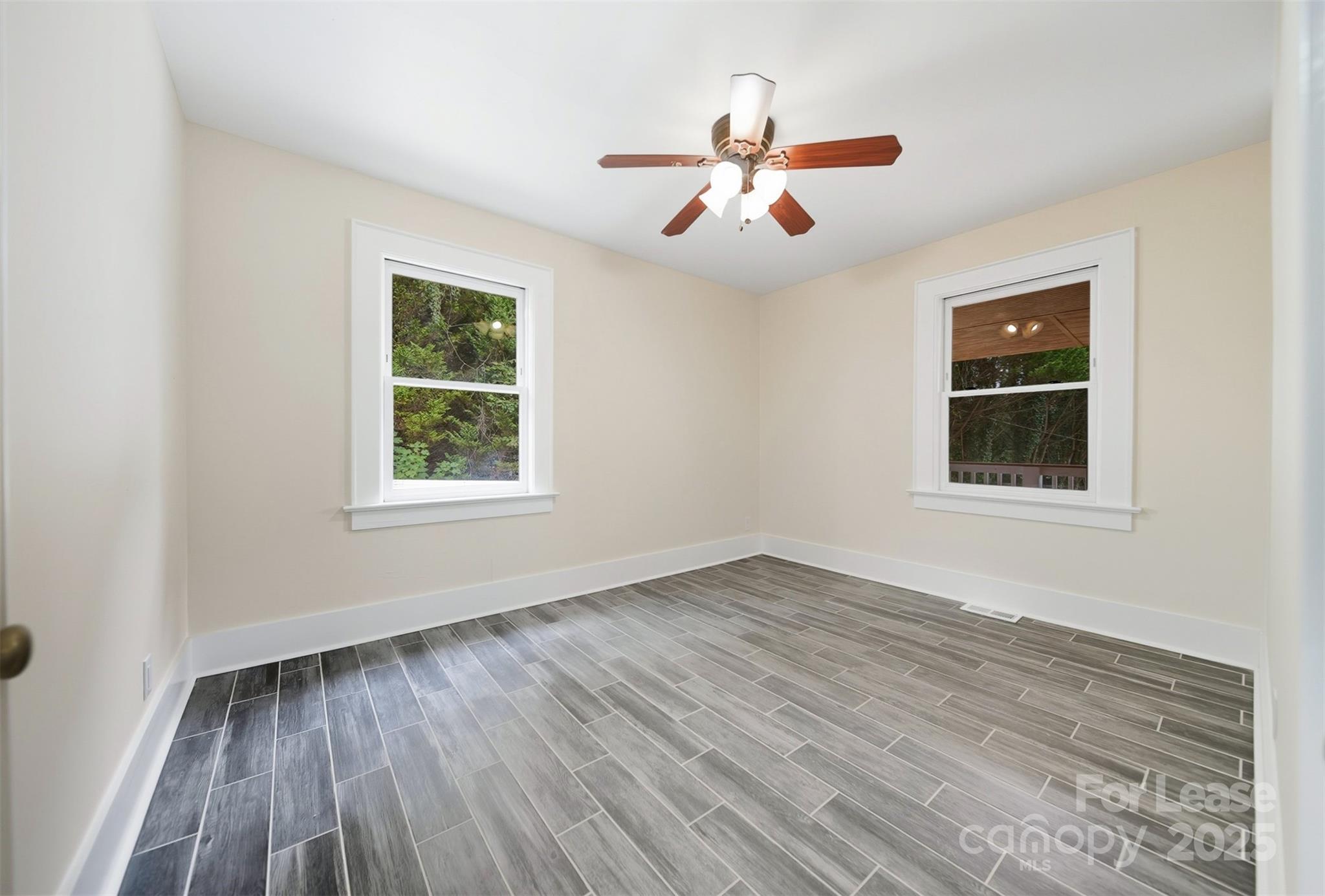 1234 11th Street Northwest Hickory, NC 28601 - Photo 9 of 19 a view of an empty room with wooden floor and a window