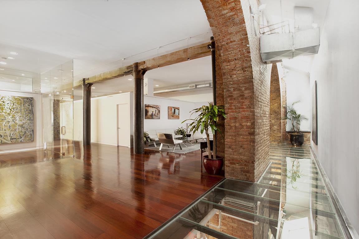 169 Hudson Street, Unit 1D Manhattan, NY 10013 - Photo 4 of 12 a hallway with a dining table and chairs