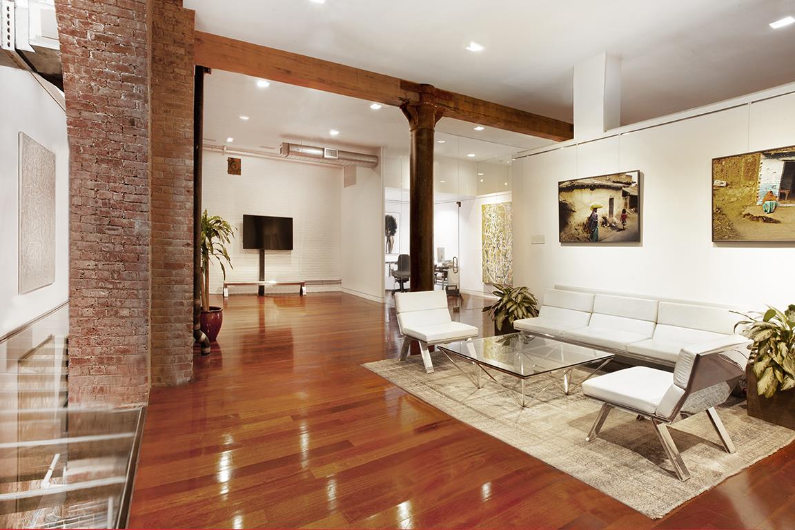 169 Hudson Street, Unit 1D Manhattan, NY 10013 - Photo 6 of 12 a living room with fireplace furniture and a rug