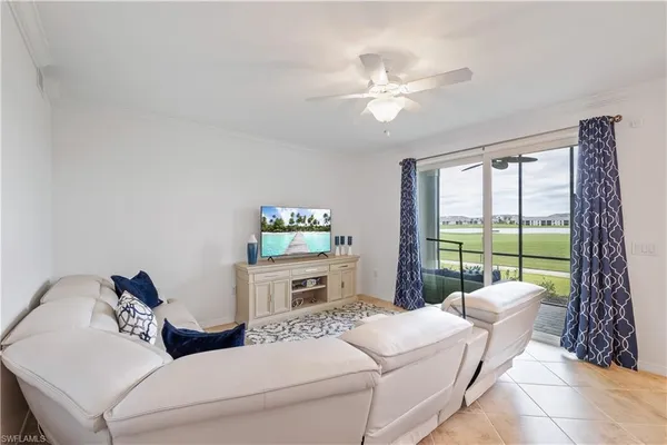 a living room with furniture and a floor to ceiling window
