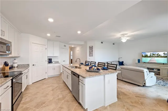 a kitchen with stove and cabinets