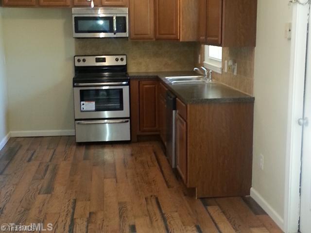 102 Westridge Drive King, NC 27021 - Photo 4 of 11 Kitchen. Remodeled kitchen with new cabinets and appliances, backsplash and countertops. New wood floors.