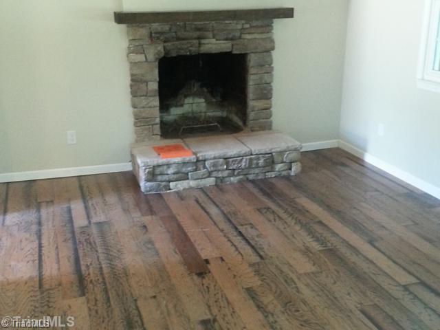 102 Westridge Drive King, NC 27021 - Photo 5 of 11 Living Room. Living room with fireplace and wood floors.