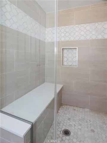 a bathroom with a bathtub and shower