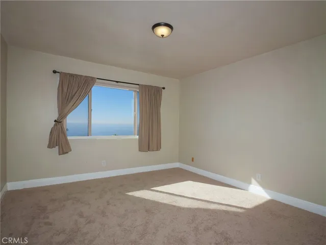 an empty room with a empty space and windows