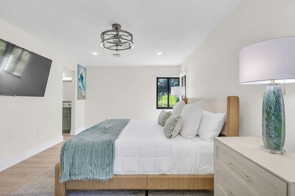 3155 64th Street Southwest Naples, FL 34105 - Photo 16 of 45 a bedroom with a bed and a flat screen tv