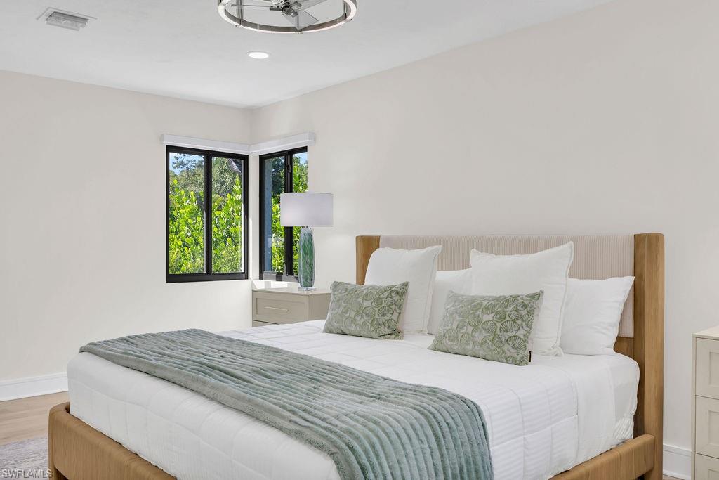 3155 64th Street Southwest Naples, FL 34105 - Photo 17 of 45 a bedroom with a bed and a window