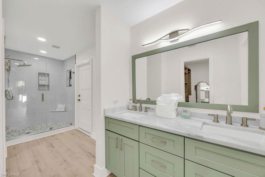 3155 64th Street Southwest Naples, FL 34105 - Photo 18 of 45 a bathroom with double sink and a mirror
