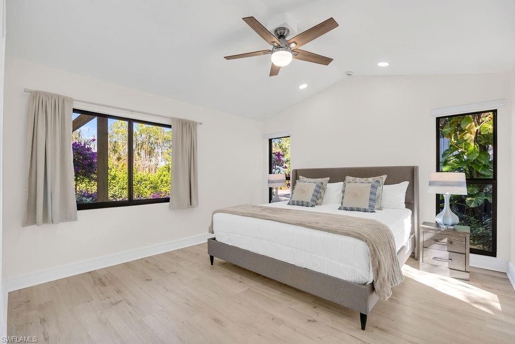 3155 64th Street Southwest Naples, FL 34105 - Photo 19 of 45 a spacious bedroom with a large bed and a large window