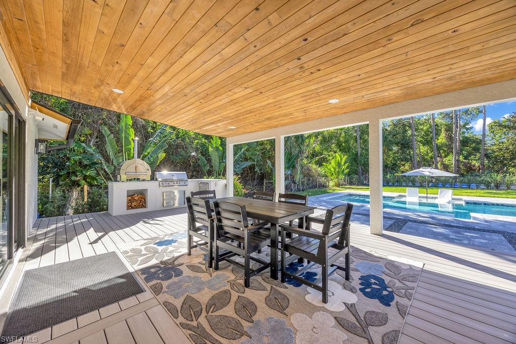 3155 64th Street Southwest Naples, FL 34105 - Photo 25 of 45 a view of a patio with a table chairs and backyard