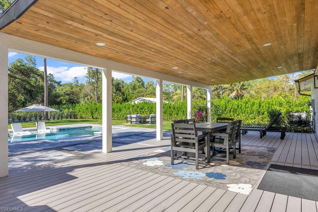 3155 64th Street Southwest Naples, FL 34105 - Photo 27 of 45 a patio with glass top table and chairs
