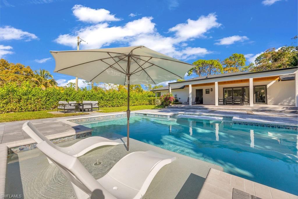 3155 64th Street Southwest Naples, FL 34105 - Photo 28 of 45 a view of a house with backyard and sitting area