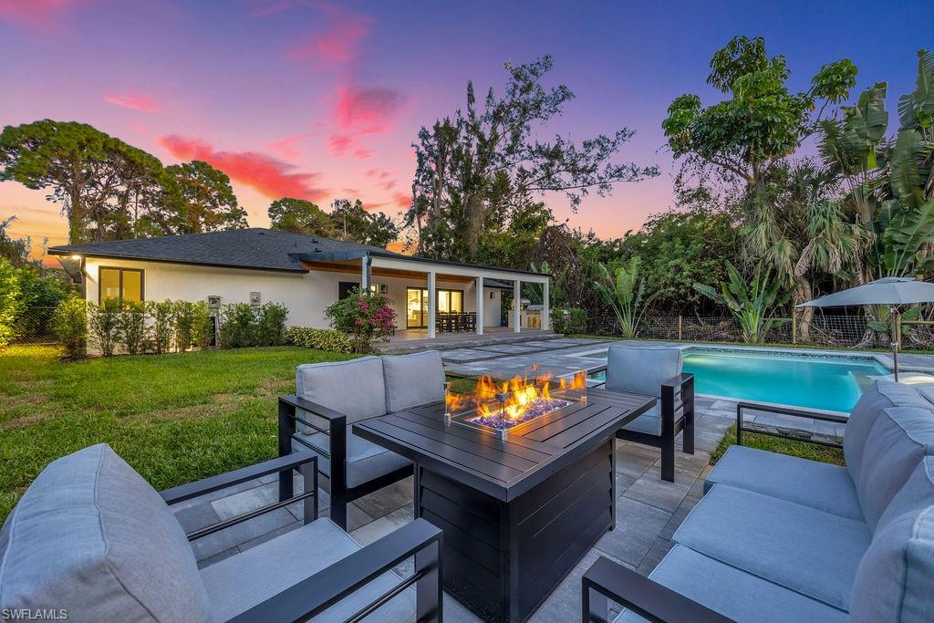 3155 64th Street Southwest Naples, FL 34105 - Photo 35 of 45 a view of a chairs and table in the back yard of a house