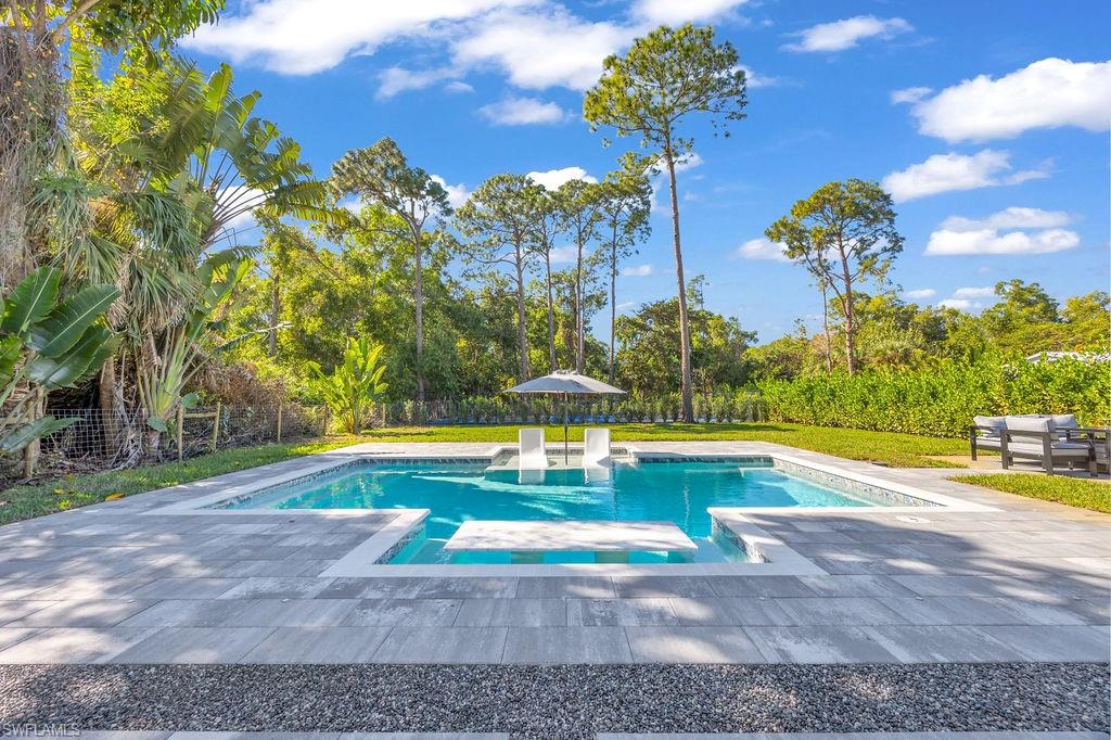 3155 64th Street Southwest Naples, FL 34105 - Photo 4 of 45 a view of a swimming pool with a yard