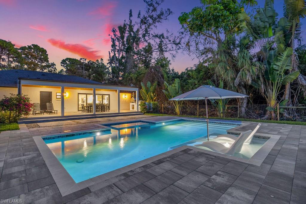 3155 64th Street Southwest Naples, FL 34105 - Photo 43 of 45 a view of a swimming pool with lounge chairs in patio