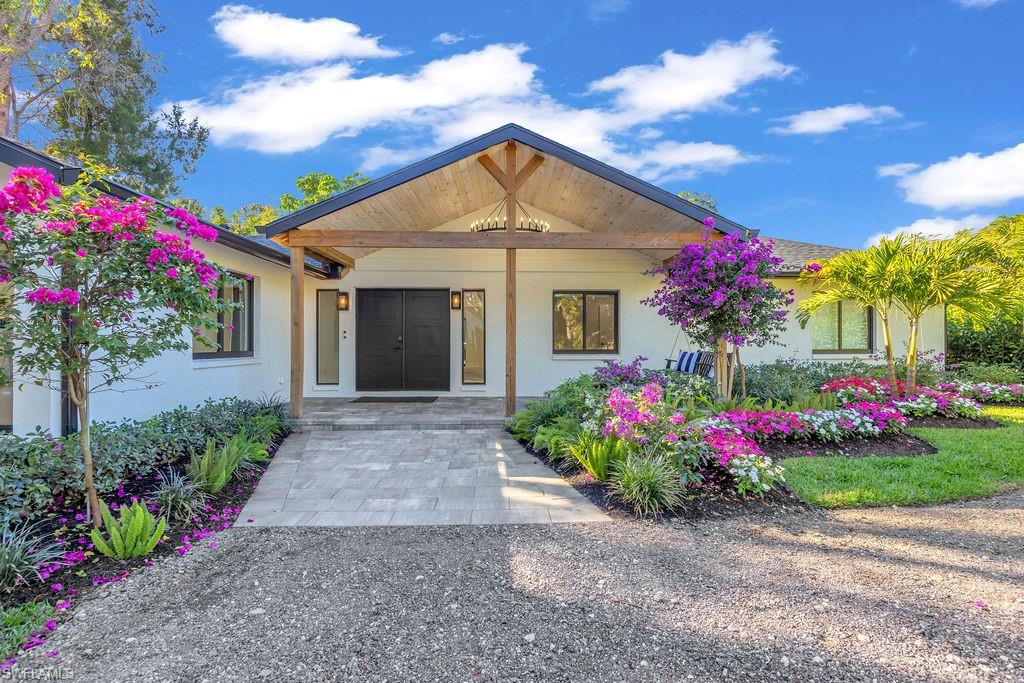 3155 64th Street Southwest Naples, FL 34105 - Photo 45 of 45 a front view of a house with a yard and fountain