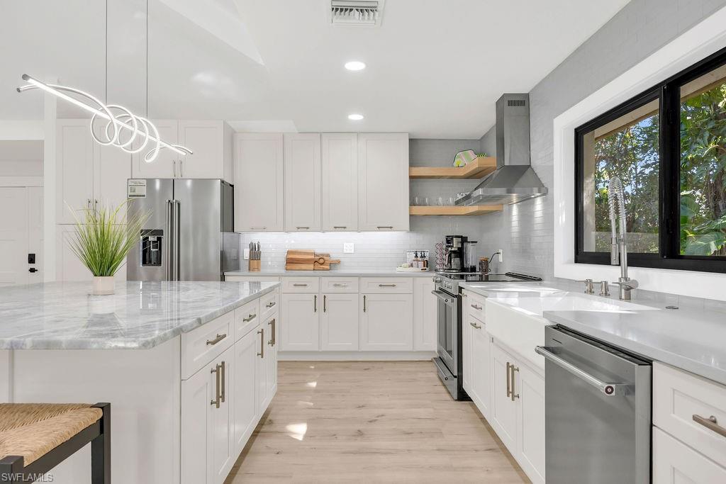 3155 64th Street Southwest Naples, FL 34105 - Photo 8 of 45 a kitchen with kitchen island granite countertop a sink appliances cabinets and furniture