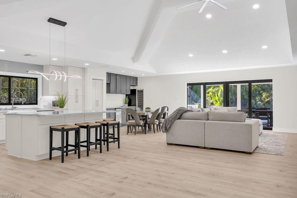 3155 64th Street Southwest Naples, FL 34105 - Photo 10 of 45 a living room with furniture a large window and dining table