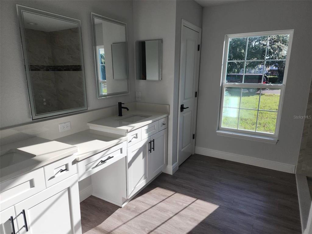 1111 Dagmar Avenue Spring Hill, FL 34606 - Photo 20 of 27 a kitchen with granite countertop a sink stove and cabinets
