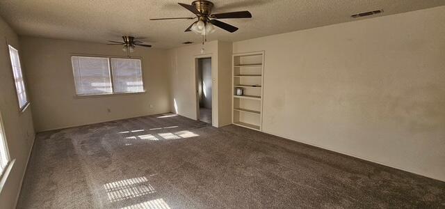 2318 33rd Street Lubbock, TX 79411 - Photo 6 of 8 en empty room with windows and ceiling fan
