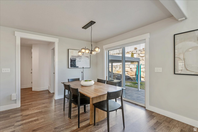 882 Spring Dew Lane Lehi, UT 84048 - Photo 14 of 46 Dining room with wood finished floors and suspended lighting