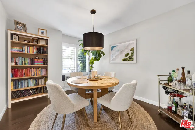 a dining room with furniture a book and wooden floor