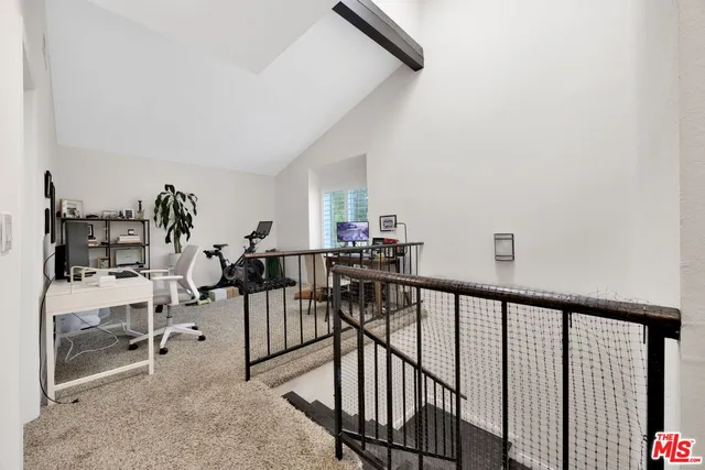 a view of a hallway with seating area