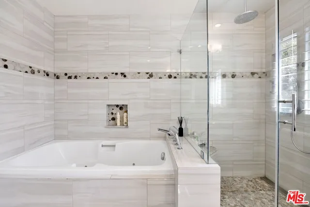 a bathroom with a bathtub and a shower