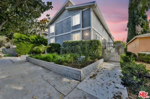 a front view of a house with lots of green space