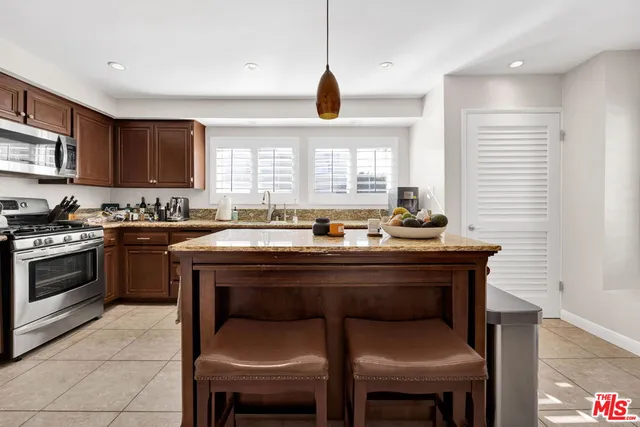 a kitchen with a sink cabinets and window