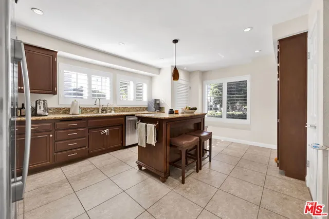 a kitchen with a sink a counter top space and appliances