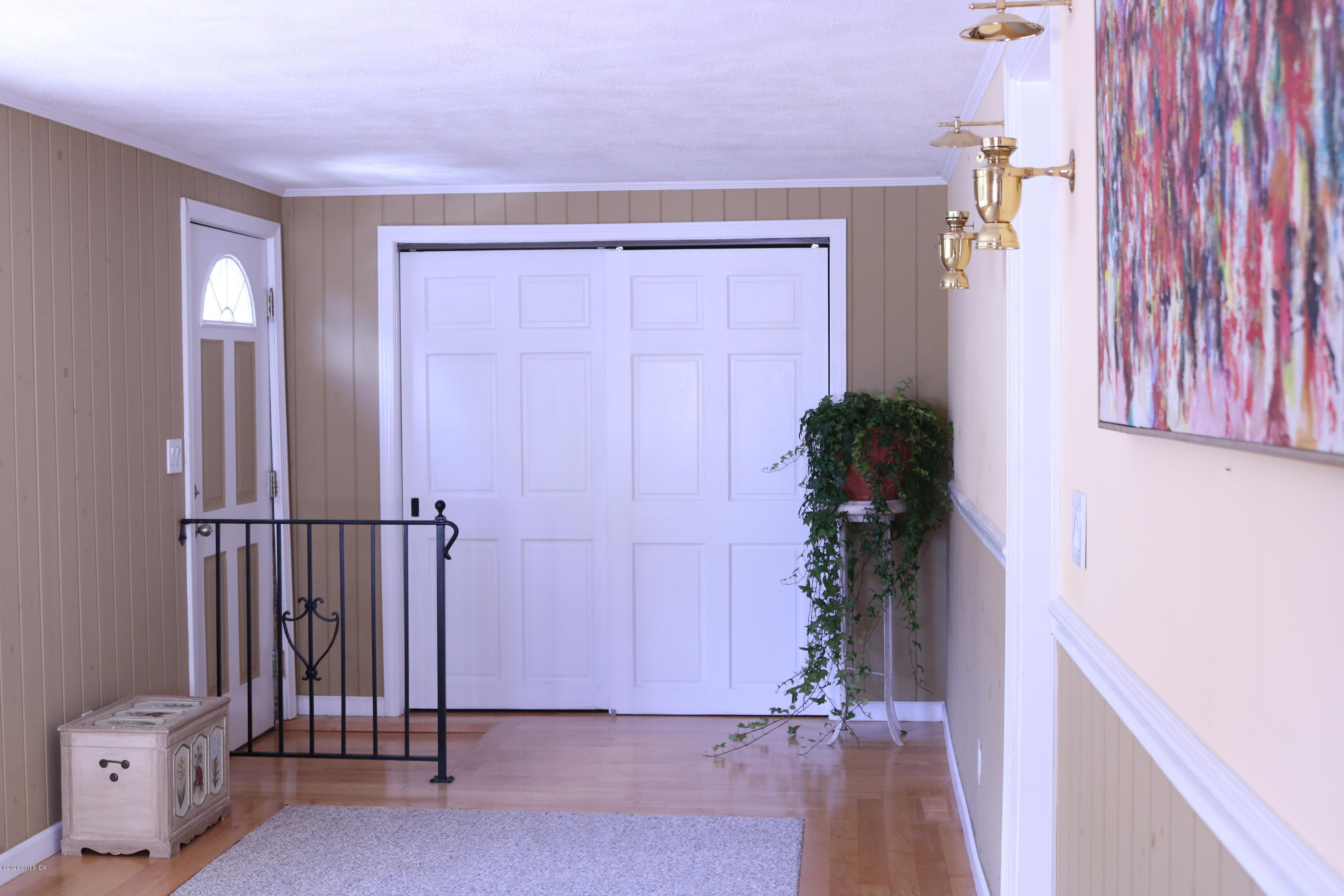 57 Shore Road Old Greenwich, CT 06870 - Photo 15 of 30 a view of a room with wooden floor and a potted plant